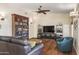 Cozy living room with hardwood floors, built-in bookshelves, and comfortable seating at 15948 W Sheila Ln, Goodyear, AZ 85395