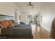 A serene primary bedroom with golf course views, a ceiling fan and plush bedding at 15948 W Sheila Ln, Goodyear, AZ 85395