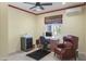 Office space with a desk, chair, ceiling fan, carpet, and a leather chair at 15948 W Sheila Ln, Goodyear, AZ 85395