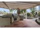 This outdoor kitchen has a built-in gas grill and a separate barbecue, perfect for outdoor entertaining at 15948 W Sheila Ln, Goodyear, AZ 85395