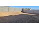 Spacious backyard shows room for a lawn with a concrete block fence at 17642 W Sanna St, Waddell, AZ 85355