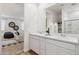 Bright bathroom featuring double sinks and a view into the main bedroom at 17642 W Sanna St, Waddell, AZ 85355