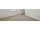 This bedroom features plush carpet and bright natural light from the window at 17642 W Sanna St, Waddell, AZ 85355