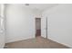 White-walled bedroom with neutral carpet and ample natural light at 17642 W Sanna St, Waddell, AZ 85355