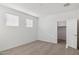 Bright bedroom with two windows, neutral carpet, and a walk-in closet at 17642 W Sanna St, Waddell, AZ 85355
