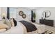 Stylishly decorated bedroom with an elegant rug, wall art, and modern furniture at 17642 W Sanna St, Waddell, AZ 85355