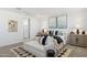 Modern bedroom with art, carpeting, a bench, and coordinated decor at 17642 W Sanna St, Waddell, AZ 85355