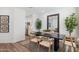 Elegant dining space with a dark wood table, seating for six, and a large decorative mirror at 17642 W Sanna St, Waddell, AZ 85355