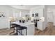 Modern kitchen featuring white cabinets, stainless steel appliances, and a center island with seating at 17642 W Sanna St, Waddell, AZ 85355