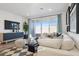 Comfortable living room with stylish furniture, a sliding glass door to the backyard, and contemporary accents at 17642 W Sanna St, Waddell, AZ 85355