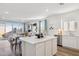 Bright, open-concept living area with a modern kitchen island and stainless appliances at 17642 W Sanna St, Waddell, AZ 85355
