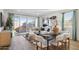 Inviting living and dining area with hardwood floors, modern furniture, and plenty of natural light at 17642 W Sanna St, Waddell, AZ 85355