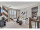 Bright living room with modern decor, comfortable seating, and a world map art piece, illuminated by natural light at 17807 W Mission Ln, Waddell, AZ 85355