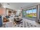 Inviting living room that flows to the kitchen with plenty of natural light from the sliding glass doors at 17807 W Mission Ln, Waddell, AZ 85355