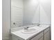 A bathroom features a double sink vanity and a large mirror at 17825 W Mission Ln, Waddell, AZ 85355