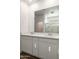 Bathroom featuring double vanity, large mirror, and tiled floors at 17825 W Mission Ln, Waddell, AZ 85355