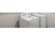 Well-maintained laundry area with newer white washing machine and clothes dryer appliances at 17825 W Mission Ln, Waddell, AZ 85355