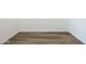 Neutral room with wood look flooring, white walls and white baseboards at 17825 W Mission Ln, Waddell, AZ 85355