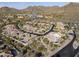 Aerial view of a neighborhood featuring tile roofs, desert landscaping, and community spaces at 18491 N 98Th Way, Scottsdale, AZ 85255