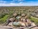 This aerial showcases the community's luxurious clubhouse, featuring multiple pools, outdoor lounge areas, and meticulously landscaped grounds at 18491 N 98Th Way, Scottsdale, AZ 85255