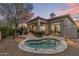 Beautiful backyard featuring a spa, covered patio, and lush landscaping; perfect for outdoor living at 18491 N 98Th Way, Scottsdale, AZ 85255