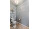 Elegant powder room with silver wallpaper, chandelier, and tile flooring at 18491 N 98Th Way, Scottsdale, AZ 85255