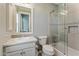 Well-lit bathroom with a vanity, toilet, and a glass-enclosed shower-tub combination at 18491 N 98Th Way, Scottsdale, AZ 85255