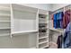 Walk-in closet with built-in shelving and hanging rods for optimal organization at 18491 N 98Th Way, Scottsdale, AZ 85255