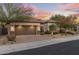 Single-story home with desert landscaping, a two-car garage, and a charming front entrance at 18491 N 98Th Way, Scottsdale, AZ 85255