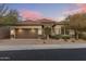Charming single-story home with a well-manicured yard and a two-car garage, set against a beautiful colorful sunset at 18491 N 98Th Way, Scottsdale, AZ 85255