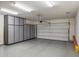 Spacious garage with ample storage cabinets and epoxy flooring; organized and functional space at 18491 N 98Th Way, Scottsdale, AZ 85255