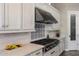 Kitchen with white cabinetry, modern appliances, and a stylish backsplash at 18491 N 98Th Way, Scottsdale, AZ 85255