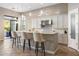 Well-lit kitchen featuring a breakfast bar, modern pendant lighting, and stainless steel appliances at 18491 N 98Th Way, Scottsdale, AZ 85255