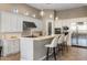 Spacious kitchen featuring a breakfast bar, white cabinetry, and stainless steel appliances at 18491 N 98Th Way, Scottsdale, AZ 85255
