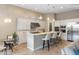 Bright kitchen with white cabinets, an island with seating, and stainless steel appliances at 18491 N 98Th Way, Scottsdale, AZ 85255