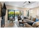 Open living room with sliding glass doors, a fireplace, and comfortable seating at 18491 N 98Th Way, Scottsdale, AZ 85255