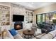 Cozy living room with a fireplace, built-in shelving, and plush sofas at 18491 N 98Th Way, Scottsdale, AZ 85255