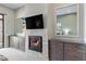 Elegant main bedroom featuring a fireplace with TV, custom cabinets and a large mirror at 18491 N 98Th Way, Scottsdale, AZ 85255