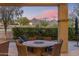 Cozy covered patio with mountain views; comfortable seating and outdoor dining for stylish relaxation at 18491 N 98Th Way, Scottsdale, AZ 85255
