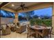 Relaxing covered patio featuring a fire pit table with comfortable seating; perfect for outdoor enjoyment at 18491 N 98Th Way, Scottsdale, AZ 85255