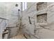 Close up of luxurious shower with bronze fixtures, mosaic floor and marble tile at 18491 N 98Th Way, Scottsdale, AZ 85255
