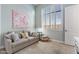 Bright room with plush sofa, stylish pillows, and a large window showcasing natural light at 18491 N 98Th Way, Scottsdale, AZ 85255