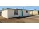 Rear view of updated home, showcasing fresh paint, tidy landscaping and attractive turquoise door at 1851 E Pleasant Ln, Phoenix, AZ 85042