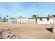 Fenced backyard with low desert landscaping, utility sheds and clear blue sky at 1851 E Pleasant Ln, Phoenix, AZ 85042