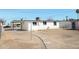 Flat backyard space with white exterior home and clear blue sky at 1851 E Pleasant Ln, Phoenix, AZ 85042