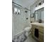 Modern bathroom with a marble-tiled shower, stylish vanity, and sleek fixtures at 1851 E Pleasant Ln, Phoenix, AZ 85042