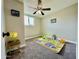 Carpeted bedroom with ceiling fan, playful decor, and natural light at 1851 E Pleasant Ln, Phoenix, AZ 85042
