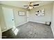 A versatile, carpeted bedroom with ceiling fan and neutral walls at 1851 E Pleasant Ln, Phoenix, AZ 85042