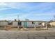 Charming single-story home featuring a fenced yard, desert landscaping, and a vibrant turquoise front door at 1851 E Pleasant Ln, Phoenix, AZ 85042