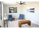 Cozy living room with stylish seating and wall art, illuminated by a modern ceiling fan at 1851 E Pleasant Ln, Phoenix, AZ 85042